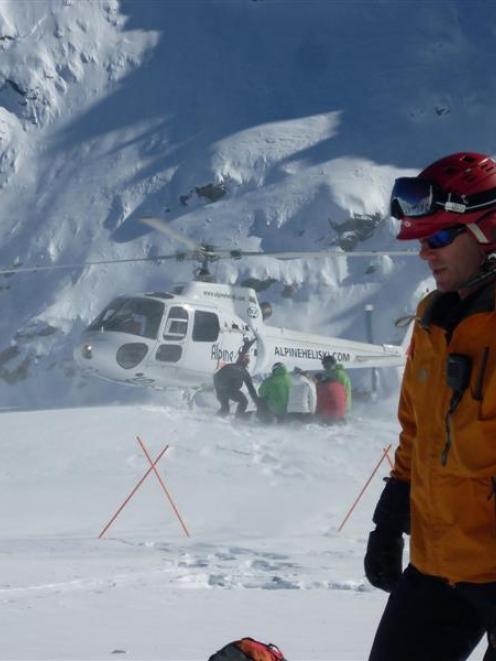 Gulmarg Heliski operations manager Tim O'Leary directs a heliskiing trip on Mt Larkin, near...