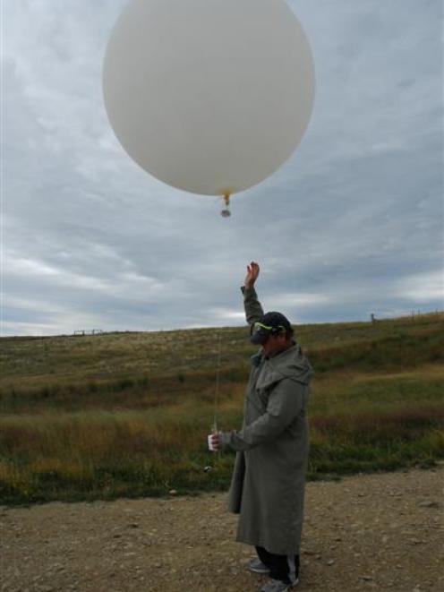Hamish Chisholm launches a balloon at the Lauder Niwa station in Central Otago yesterday shortly...
