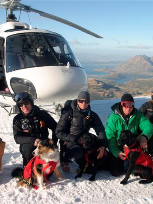 Handlers and dogs of the Wanaka Search and Rescue search-dog team at their first helicopter...