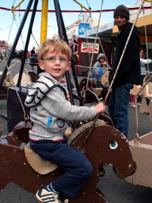 Cameron Marriott (4) enjoys a ride on the merry-go-round at the South Dunedin Street Festival on...