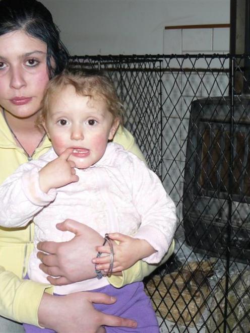 Harata Gemmell and her daughter Mariah sit beside their empty fireplace after their firewood was...