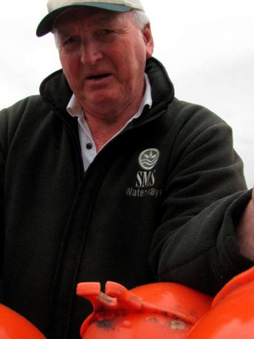 Harbourmaster Marty Black with three of the buoys cut from the safe swimming area in Roys Bay,...