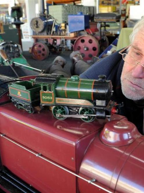 Hayward's Auction House auctioneer Kevin Hayward, of Dunedin, inspects a hand-built live steam...