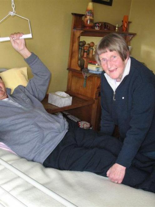 Heather Turner helps her husband Ted, who has spastic tetraplegia as a result of a malignant...
