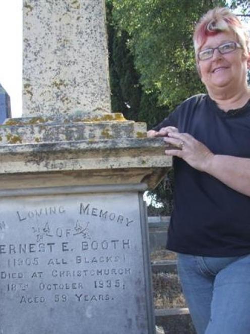 Heather Woodrow beside the grave of 1905 All Black Ernest Booth in the old Oamaru cemetery. Photo...