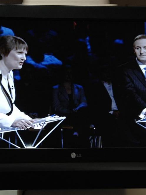 Helen Clark speaks while John Key listens, on television last night. Photo by Linda Robertson.