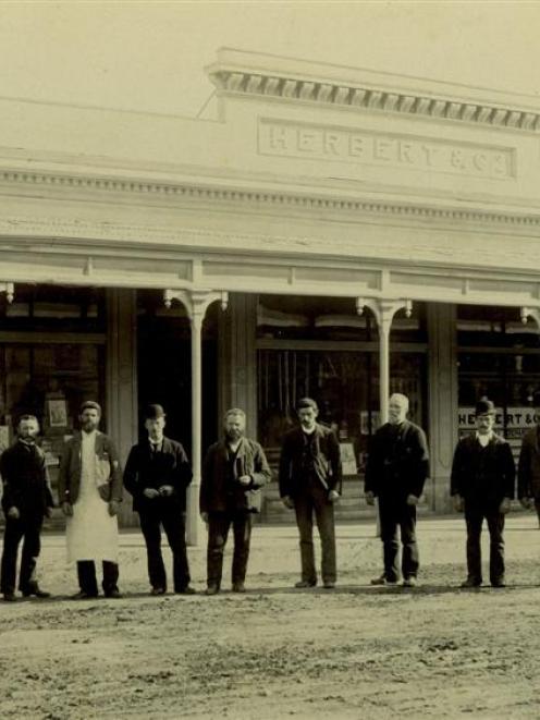 Herbert and Co. owner Archibald McKinlay (left) lines up with staff (from second left) A. McLean,...