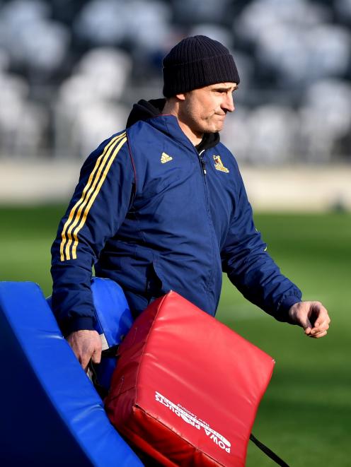 Sssistant coach Scott McLeod brings on the tackle bags during a Highlanders training session at...