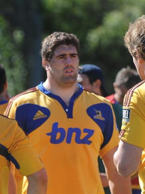 Highlanders Jason Macdonald (left) and Adam Thomson (right) talk to Jamie Macintosh while wearing...