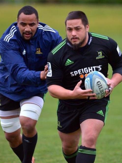 Highlanders prop Kane Hames, supported by No 8 Nasi Manu (left) carts the ball up at training at...