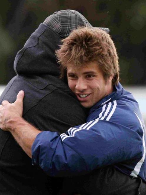 Highlanders winger James Paterson (right) greets prop Jamie Mackintosh at training yesterday.