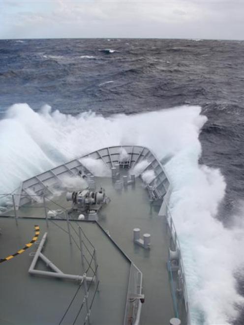 HMNZS<i> Otago </i>plows through a big wave in the southern ocean. Photos by the New Zealand...