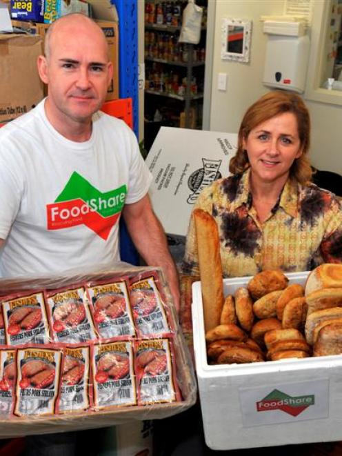 Holding  food rescued from being thrown away are University of Otago MBA student Nick Bell and...