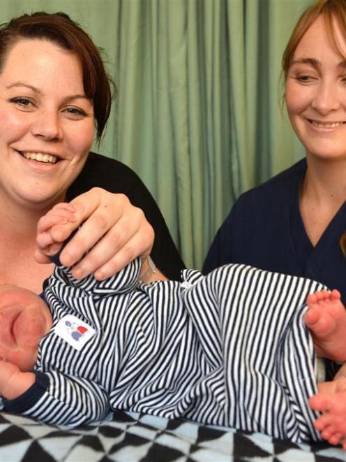 Holly Taylor (left) with son Archie Patison and midwife Angel Temple at Queen Mary Maternity...