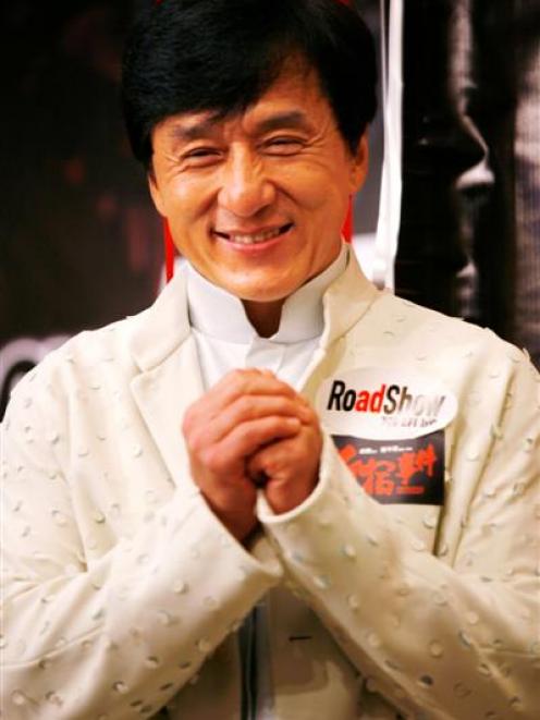 Hong Kong action star Jackie Chan gestures during a press conference to promote his new moive ...