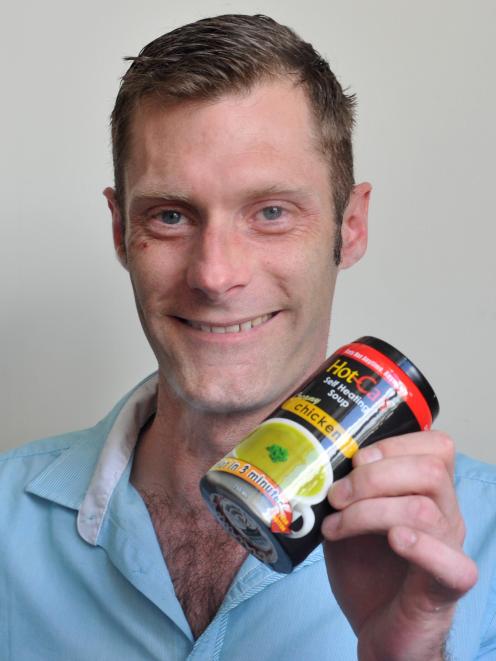 Hot-Can NZ Ltd managing director Craig Darling holds a steaming can of self-heating chicken soup...