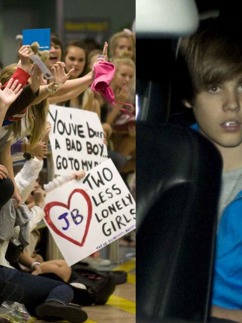 Hundreds of fans wait at the international airport for the arrival of singer Justin Bieber but he...