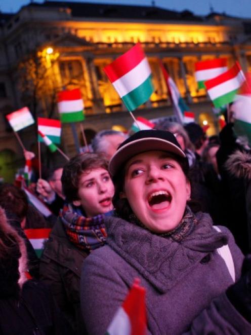 Hungarians shout slogans during a demonstration against the far-right opposition Jobbik party in...