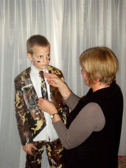 Hunter Bennett is fitted with a camouflage suit by Heleen Johnston. Photo by Haast School.