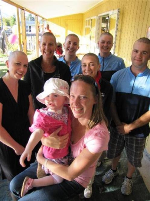 Ciara Hovey (2) and her mum, Jane Hovey, are surrounded by Oanaka Educare Centre workers before...
