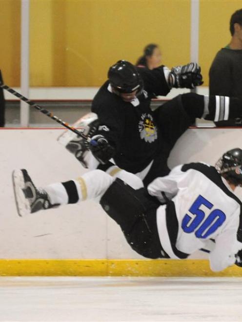 Ice Black player Hayden Argyle clashes with HC Storm player Dane Dunlop (No 50) at the Dunedin...