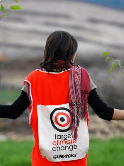 Dimitri Sharamov's picture of Greenpeace volunteer Tanith Carrington planting a tree as part of...