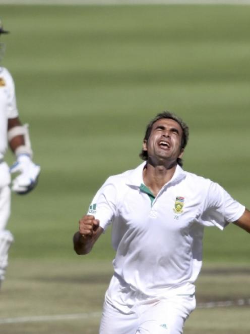 Imran Tahir (R) of South Africa celebrates after bowling Kumar Sangakkara of Sri Lanka during the...