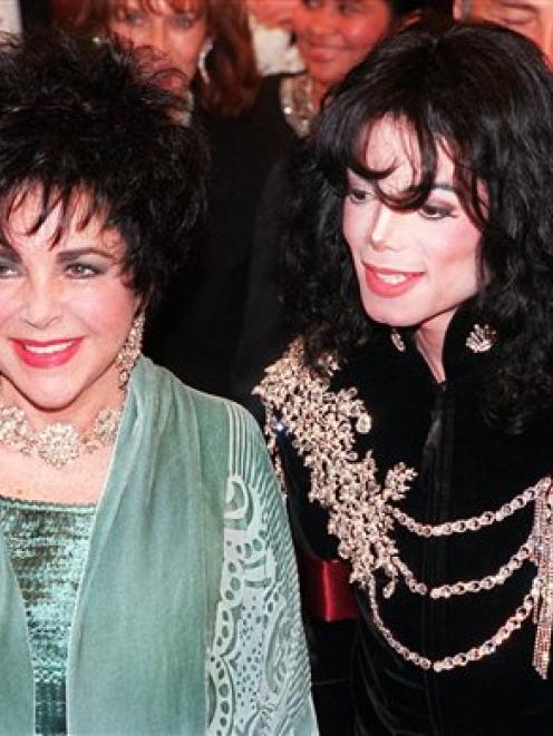 In this 1998 AP file photo, actress Elizabeth Taylor arrives with pop singer Michael Jackson at...