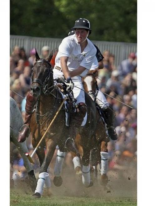 In this 2009 AP file photo, Prince Harry of Wales plays polo.
