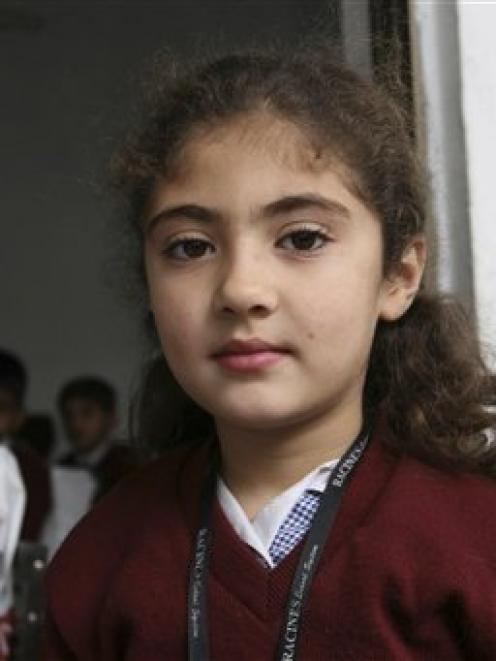 In this AP image taken on December 3, 2009, 8-year-old Pakistani student Saira Khan, is seen...