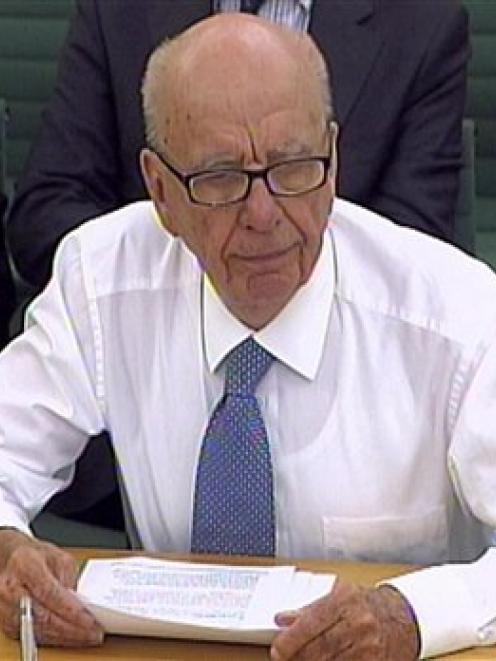 In this image made from television, Rupert Murdoch, following an attempted assault, gives...