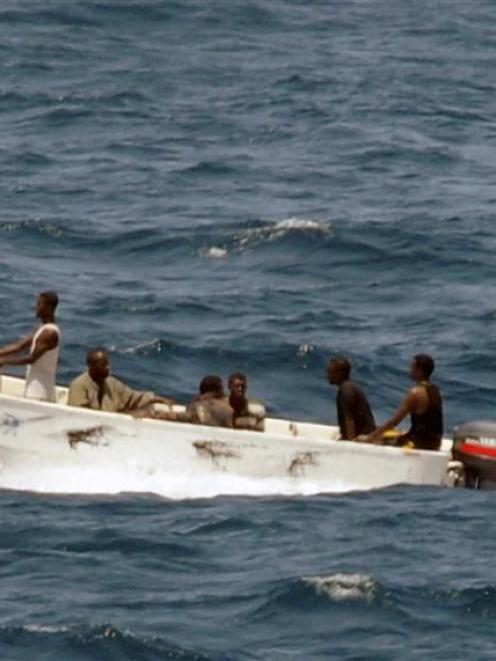 In this photo provided by the U.S. Navy, pirates leave the hijacked Ukrainian merchant vessel MV...