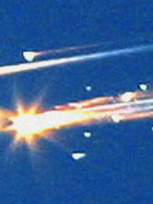 In this Saturday, February 1, 2003 file photo, debris from the space shuttle Columbia streaks...