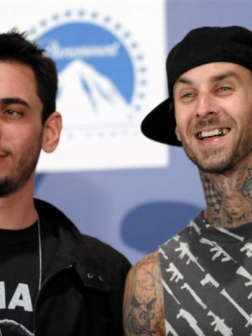 In this September 7, 2008 file photo, DJ AM, left, and musician Travis Barker pose backstage at...