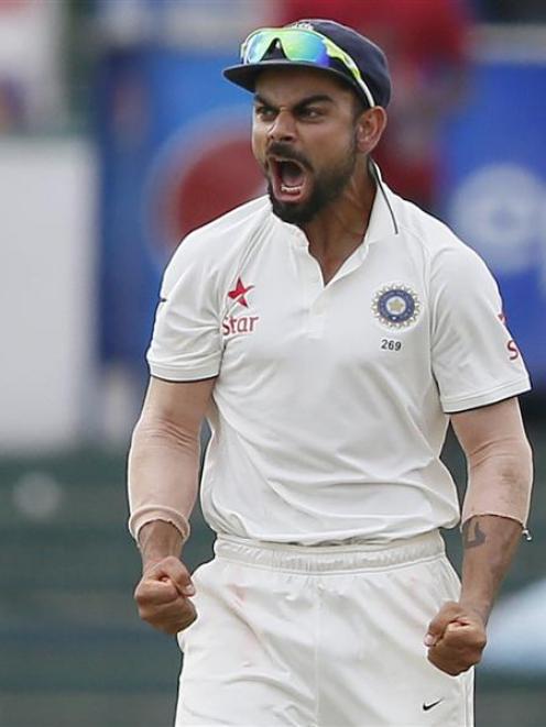 India captain Virat Kohli celebrates after taking a catch on day four of their match against Sri...