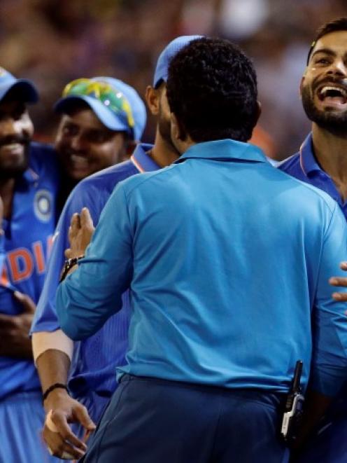 India's Virat Kohli (R) celebrates with teammates after they beat South Africa at the Melbourne...