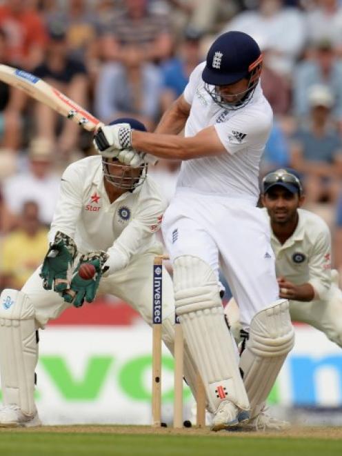 India wicketkeeper Mahendra Singh Dhoni takes a catch to dismiss England captain Alastair Cook....