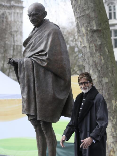 Indian actor Amitabh Bachchan poses for a photograph after the unveiling of a statue of Mahatma...