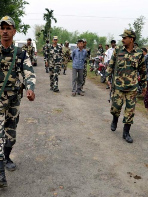 Indian security personnel patrol the attack-hit area of the Balapara village in the northeastern...