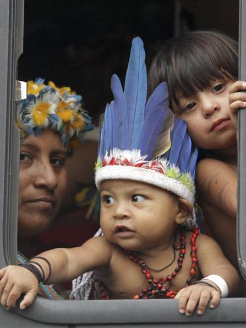 Indigenous people arrive at a meeting by bus during the Rio+20 United Nations Conference on...
