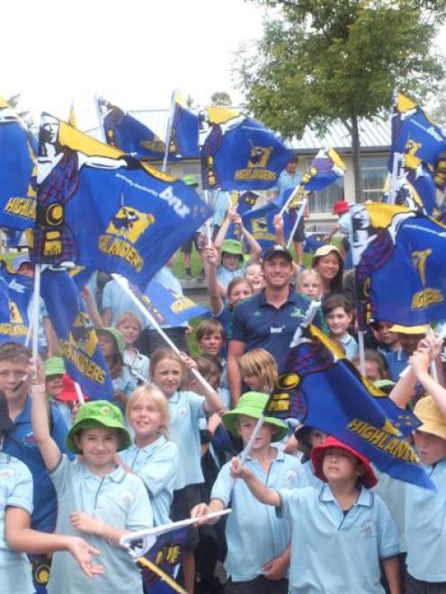 Injured Highlanders fullback Ben Smith is surrounded by hundreds of excited rugby fans at...