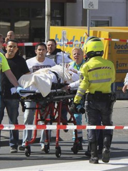 Injured people are carried out of a shopping mall after a shooting in Alphen aan den Rijn,...