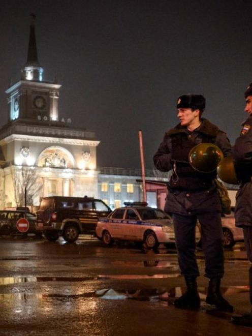 Interior Ministry members stand guard in front of the train station in Volgograd. REUTERS/Sergei...