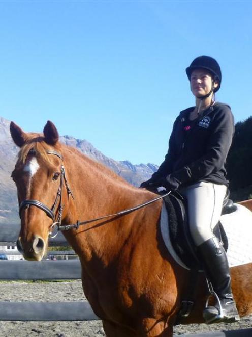 International riding instructor Suzanne Kolff sits next to the round pen used for horsemanship...