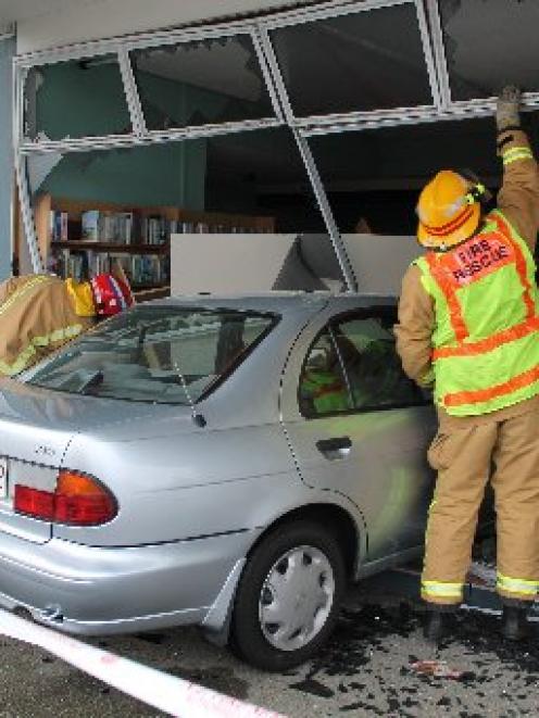 Invercargill firefighters check out the frontage of the book  exchange shop in the Glengarry...