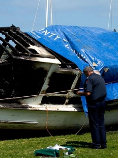 Investigators at the scene of a fatal boat fire on Waiheke Island. Photo / Dean Purcell