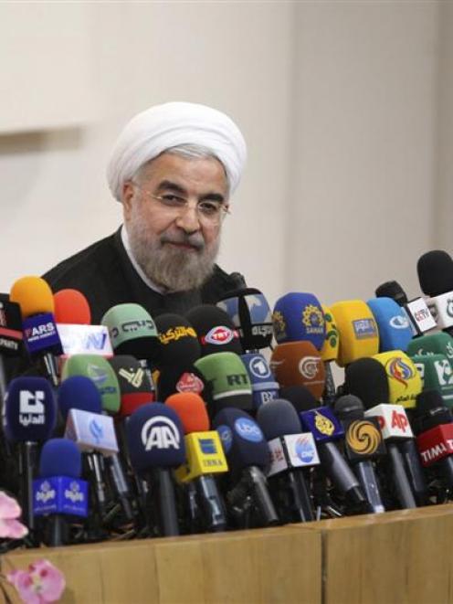 Iranian President-elect Hassan Rowhani speaks with the media during a news conference in Teheran...