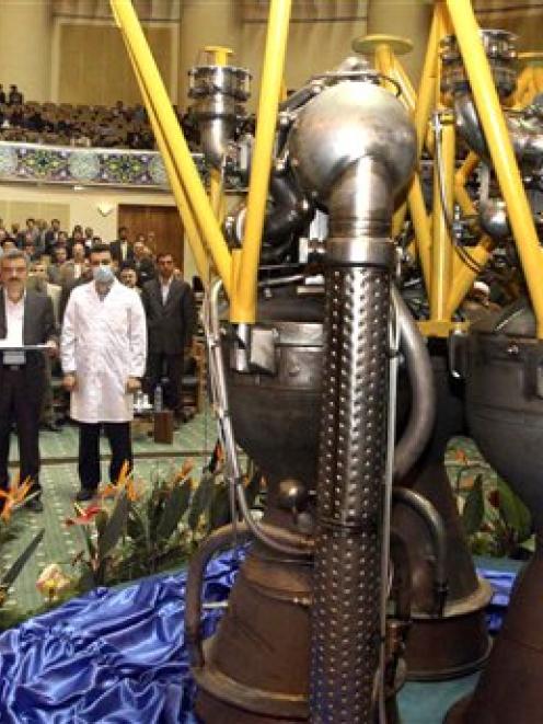 Iranian President Mahmoud Ahmadinejad, left, listens to his Defence Minister Gen. Ahmad Vahidi,...