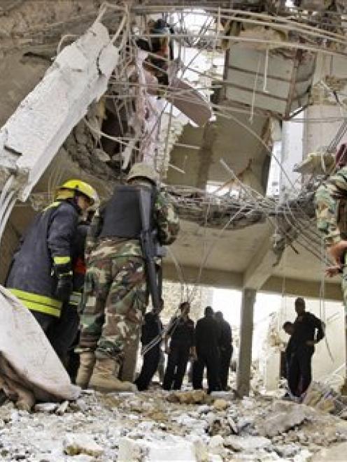 Iraqi security forces inspect the scene where a blast killed seven people in the Hurriya...