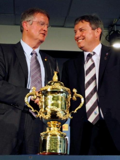 IRB Chairman Bernard Lapasset (L) and Rugby New Zealand 2011 Limited CEO Martin Snedden pose...